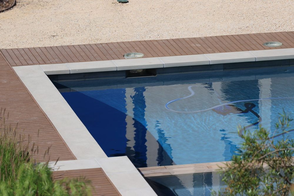 Residential swimming pool with pool-cleaning equipment