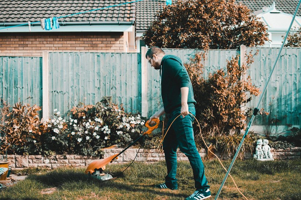 Landscaper mowing a residential lawn
